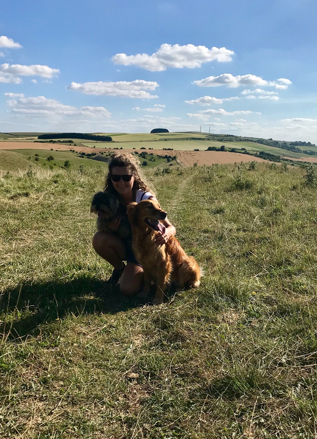 Issy on a hillside with her two dogs